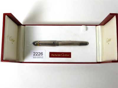 Lot 2226 - Cartier: A Pasha de Cartier Ballpoint Pen, with a silver barrel and cap, in original box with...