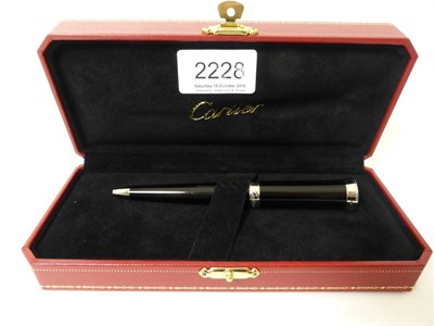 Lot 2228 - Cartier: An Art Deco Style Ballpoint Pen ST60004, in original presentation box, with leaflet...