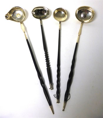 Lot 2243 - Four Punch Ladles, 18th-20th century, each with a twisted baleen handle and three with a coin...