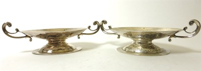 Lot 2302 - A Pair of Silver Twin-Handled Dishes, Daniel & John Wellby, London 1908, each oval with twin scroll