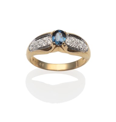 Lot 2009 - A Sapphire and Diamond Ring, an oval cut sapphire in a yellow claw setting, to white eight-cut...