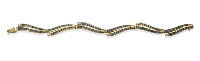 Lot 2012 - A Sapphire and Diamond Bracelet, with two rows of calibré cut sapphires in yellow channel settings