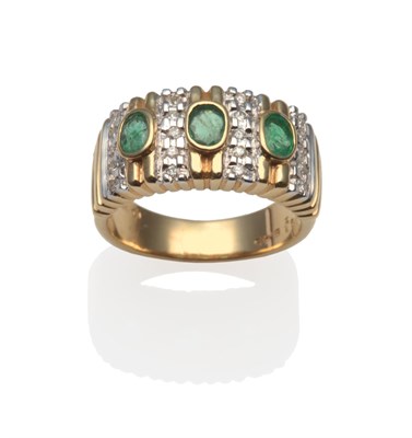 Lot 2014 - An Emerald and Diamond Ring, three oval cut emeralds in yellow rubbed over settings, spaced by...