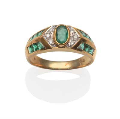 Lot 2018 - An Emerald and Diamond Ring, an oval cut emerald in a yellow rubbed over setting, flanked by...