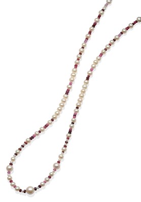 Lot 2026 - A Cultured Pearl and Ruby Bead Necklace, graduated round cultured pearls spaced by groups of...