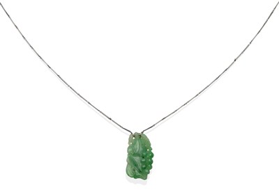 Lot 2037 - A Carved Jade Pendant, depicting fruiting vines and a bird, on a long and short link chain, pendant