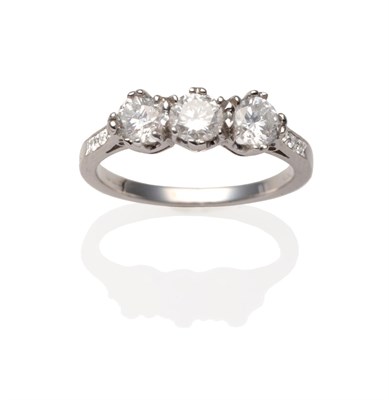 Lot 2038 - An 18 Carat White Gold Diamond Three Stone Ring, the round brilliant cut diamonds in white claw...