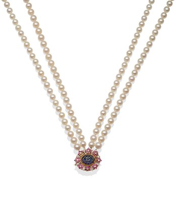 Lot 2046 - A Four Row Cultured Pearl Necklace, the uniform pearls knotted to a sapphire, ruby and diamond...