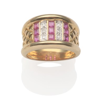 Lot 2051 - A Ruby and Diamond Ring, with three columns of calibré cut rubies in yellow channel settings,...