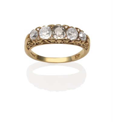 Lot 2055 - An 18 Carat Gold Diamond Five Stone Ring, the graduated old cut diamonds in yellow carved...