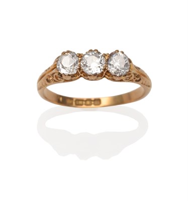 Lot 2058 - An 18 Carat Gold Diamond Three Stone Ring, three old cut diamonds in yellow claw settings, to a...