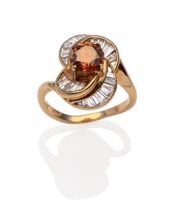 Lot 2061 - A Diamond Cluster Ring, a round brilliant cut cognac coloured diamond in a yellow four claw setting