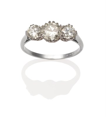 Lot 2070 - A Diamond Three Stone Ring, the graduated brilliant cut diamonds in white claw settings, on a plain