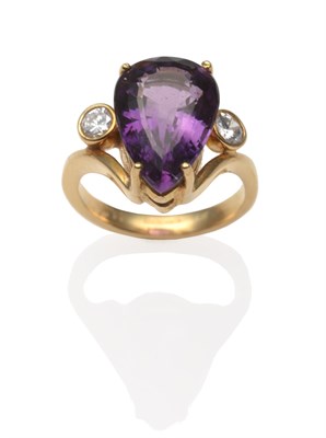 Lot 2097 - An 18 Carat Gold Amethyst and Diamond Ring, a pear cut amethyst in a yellow four claw setting...