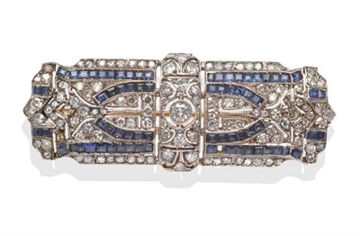 Lot 2106 - An Art Deco Style Sapphire and Diamond Brooch, a central round brilliant cut diamond and...