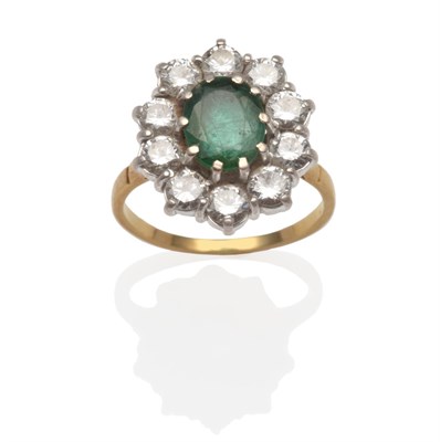 Lot 2111 - An Emerald and Diamond Cluster Ring, an oval cut emerald within a border of round brilliant cut...