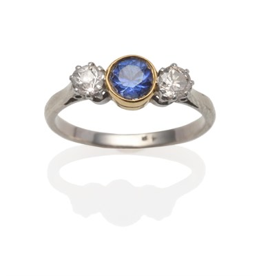 Lot 2116 - A Sapphire and Diamond Ring, a central round cut sapphire in a yellow rubbed over setting...