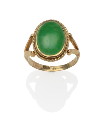 Lot 2124 - A Jade Ring, an oval jade cabochon in a yellow bezel setting within a rope border, to...