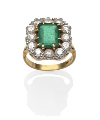 Lot 2126 - An 18 Carat Gold Emerald and Diamond Cluster Ring, an emerald-cut emerald within a border of...