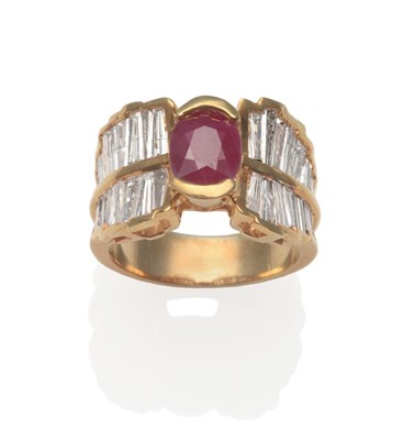 Lot 2133 - A Ruby and Diamond Cluster Ring, an oval cut ruby in yellow half rubbed over setting, flanked...