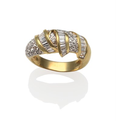 Lot 2136 - A Diamond Ring, with scrolls of baguette cut diamonds in yellow channel settings, amongst pavé set