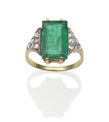 Lot 2137 - An Emerald and Diamond Ring, a step-cut emerald in a yellow four claw setting between old cut...