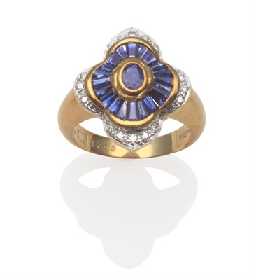 Lot 2149 - A Sapphire and Diamond Ring, an oval cut sapphire in a yellow rubbed over setting within a...