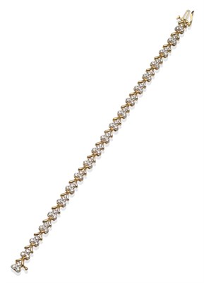 Lot 2152 - A Diamond Bracelet, formed of links each set with three round brilliant cut diamonds in white...