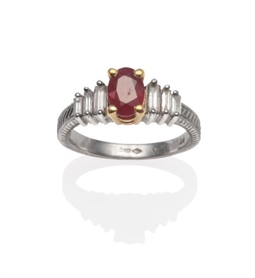 Lot 2164 - A Platinum Ruby and Diamond Ring, an oval cut ruby in a yellow four claw setting, to graduated...