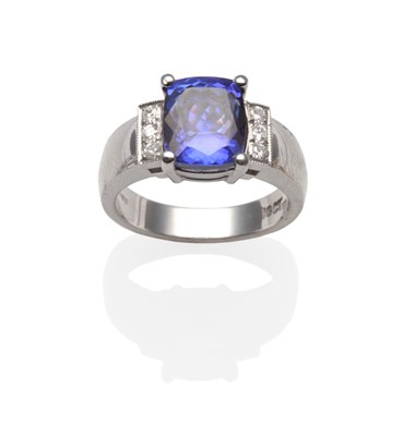 Lot 2166 - An 18 Carat White Gold Tanzanite and Diamond Dress Ring, a cushion cut tanzanite in a four claw...