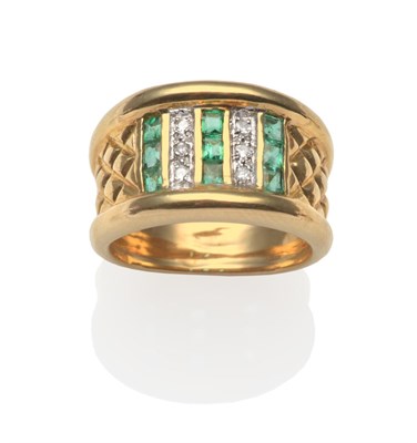 Lot 2198 - An Emerald and Diamond Ring, with three columns of calibré cut emeralds in yellow channel...