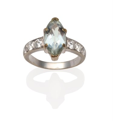 Lot 2203 - An Aquamarine and Diamond Ring, a marquise cut aquamarine in a white claw setting to shoulders each