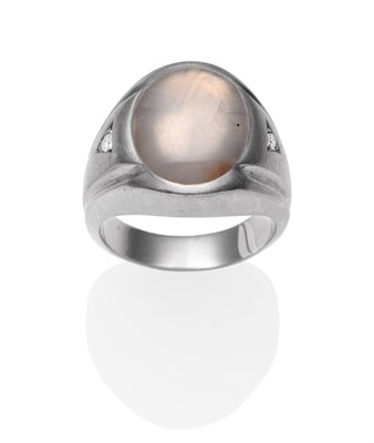 Lot 2204 - A Star Sapphire and Diamond Signet Ring, a grey oval cabochon star sapphire in a white rubbed...