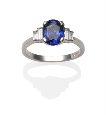 Lot 2206 - A Platinum Sapphire and Diamond Ring, an oval cut sapphire in a white four claw setting,...