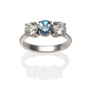 Lot 2207 - An 18 Carat White Gold Aquamarine and Diamond Ring, a round cut aquamarine between two round...