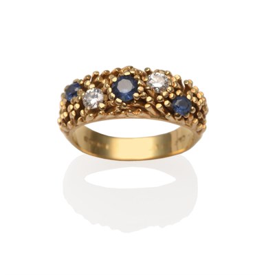 Lot 2212 - An 18 Carat Gold Diamond and Sapphire Ring, three graduated round cut sapphires spaced by two round