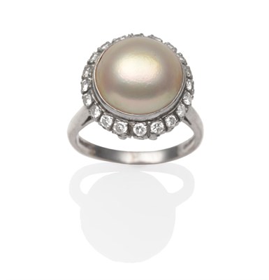 Lot 2220 - An 18 Carat White Gold Mabe Pearl and Diamond Cluster Ring, a mabe pearl in a white rubbed over...