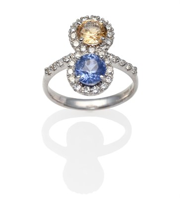 Lot 2226 - An 18 Carat White Gold Blue and Yellow Sapphire and Diamond Ring, round cut blue and yellow...