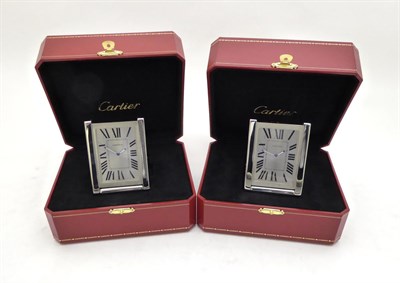 Lot 2269 - Two Travelling Alarm Timepieces, signed Cartier, model: Tank, circa 2010, the first, quartz...