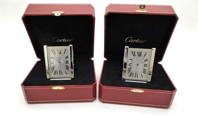 Lot 2270 - Two Travelling Alarm Timepieces, signed Cartier, model: Tank, circa 2010, the first, quartz...