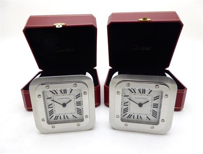 Lot 2271 - Two Travelling Timepieces, signed Cartier, model: Santos De Cartier, circa 2010, the first,...