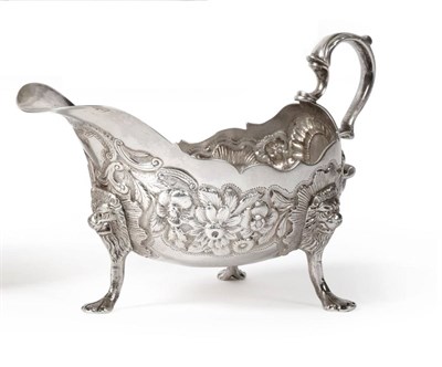 Lot 2341 - An 18th Century Irish Silver Sauce Boat, worn marks, the sides chased with flowers over a matte...