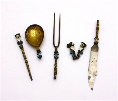 Lot 2401 - A 19th Century Renaissance Revival Silver Gilt and Enamel Knife, Fork and Spoon Set, apparently...