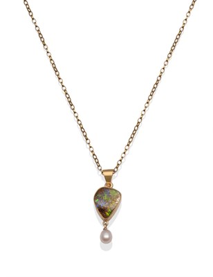 Lot 2003 - A Black Opal and Cultured Pearl Pendant, a rough black opal in a yellow milgrain setting,...