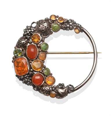 Lot 2006 - An Arts and Crafts Brooch, by Dorrie Nossiter, set throughout with vari-cut peridot, citrine,...