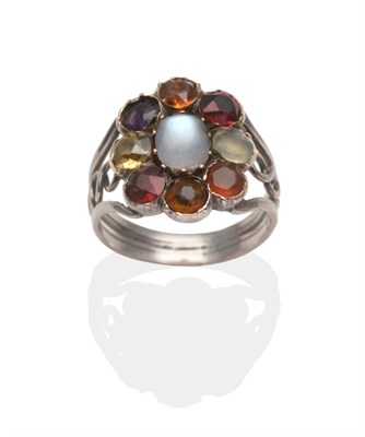 Lot 2007 - An Arts and Crafts Style Multi-Gemstone Ring, an oval moonstone within a border of round cut...