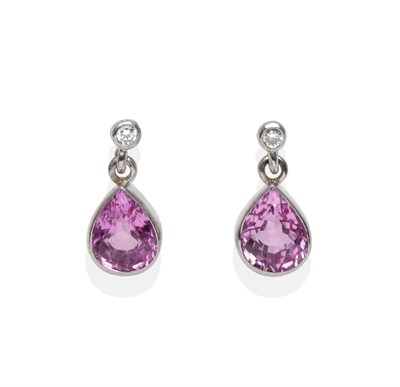 Lot 2011 - A Pair of 18 Carat White Gold Pink Sapphire and Diamond Earrings, a round brilliant cut diamond...