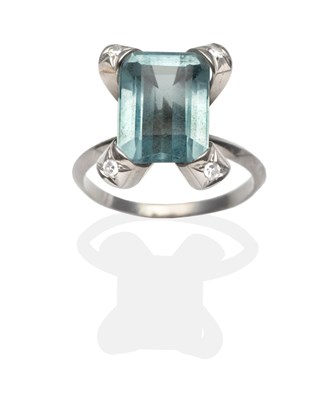 Lot 2014 - An Aquamarine and Diamond Ring, an emerald-cut aquamarine in a white claw setting, each claw...