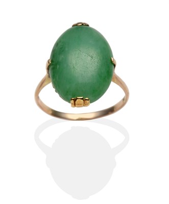 Lot 2015 - A Jade Ring, an oval cabochon jade in a yellow claw setting with a scroll pierced under bezel, on a