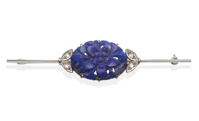 Lot 2017 - A Lapis Lazuli and Diamond Bar Brooch, an oval lapis lazuli plaque carved and pierced with a floral